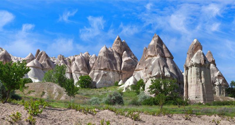 Large fairy chimneys in a valley on sunny day