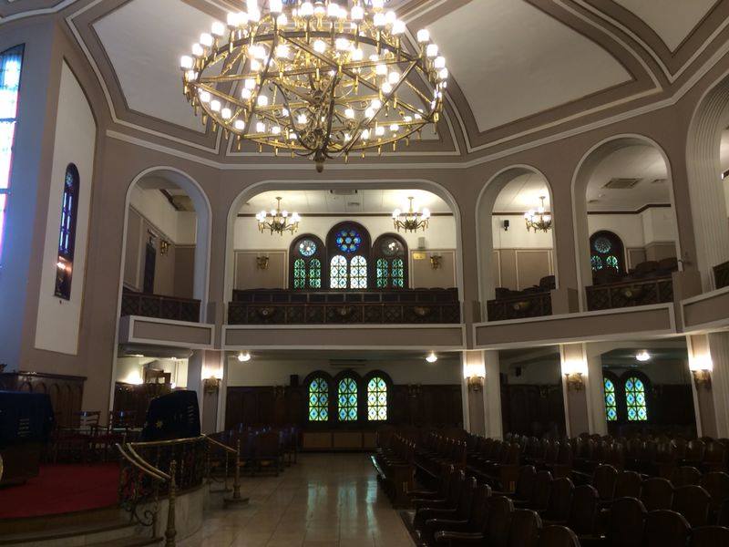 Ground level view inside synagogue with chandelier
