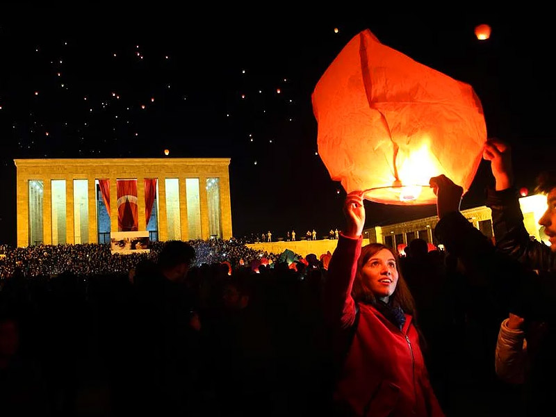 Young women in large crowd lighting lantern at Ataturk´s mausoleum