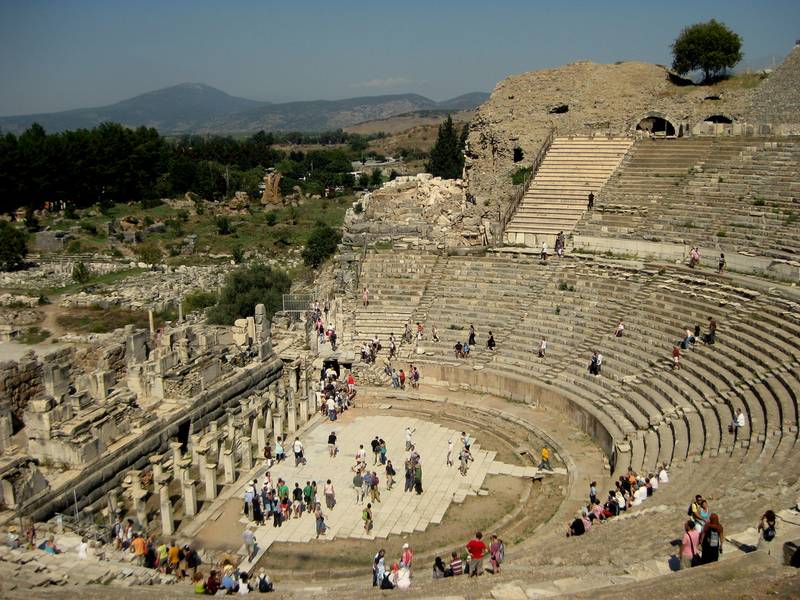 Ephesus Amphitheatre and tourists exploring the site